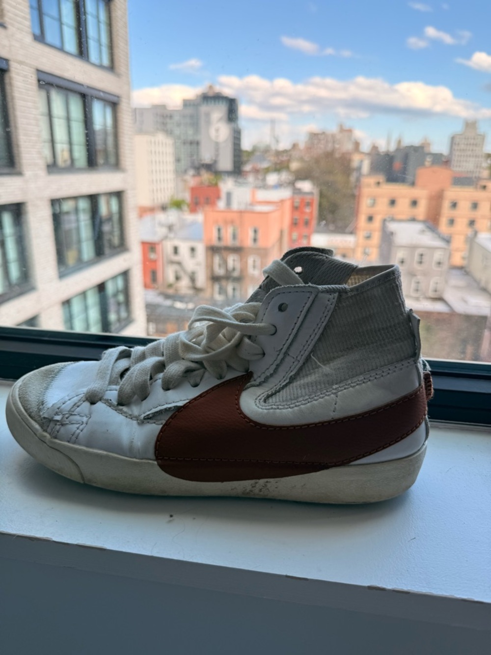 Nike White High-Top Sneakers with Brown Swoosh